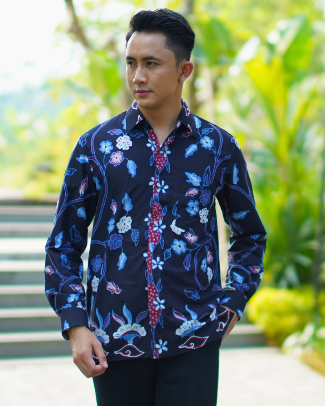 Person wearing collar dress shirt with motif pattern and buttons.