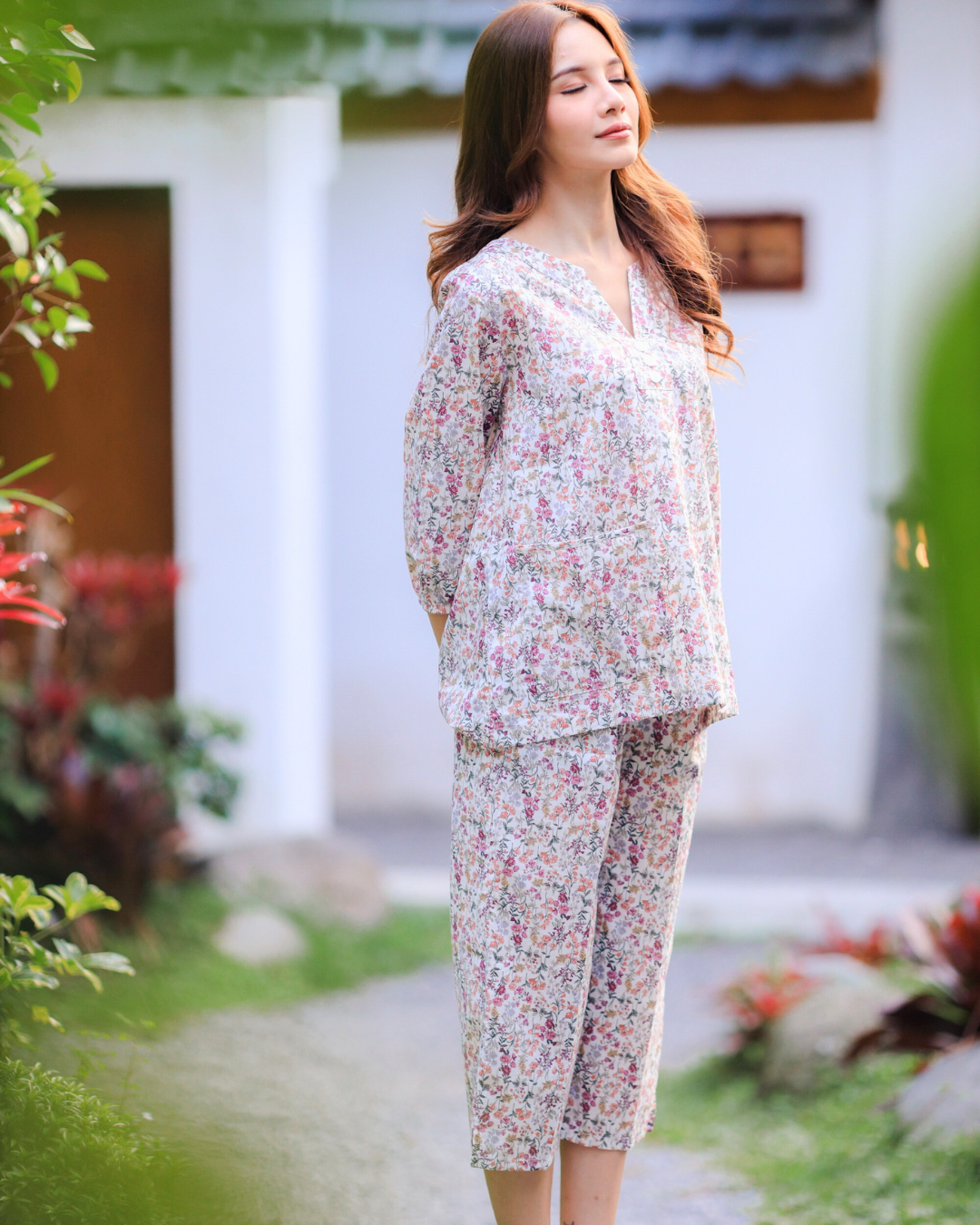 Pink floral pajama set worn by model.
