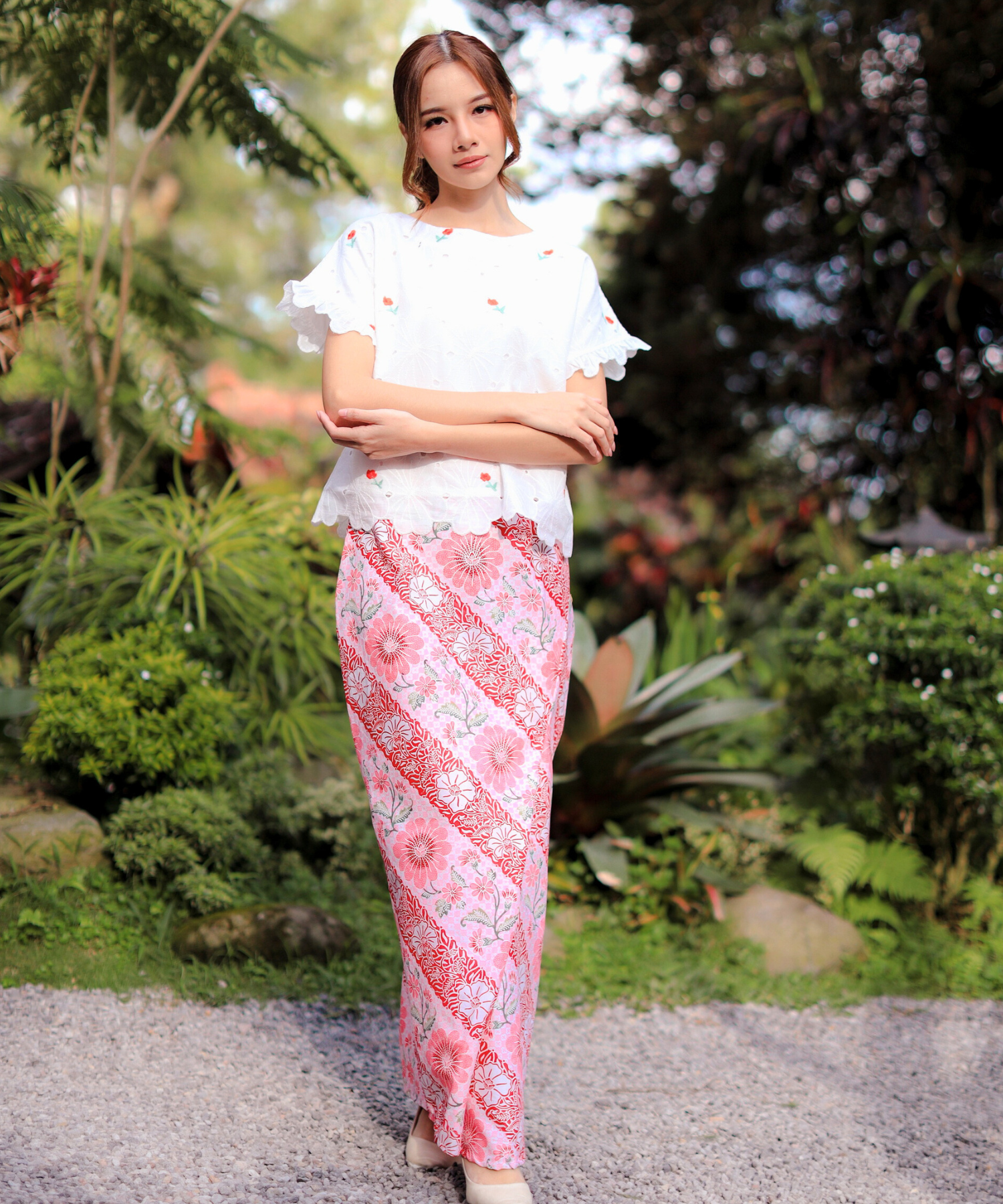 Fashion model in pink top and skirt.