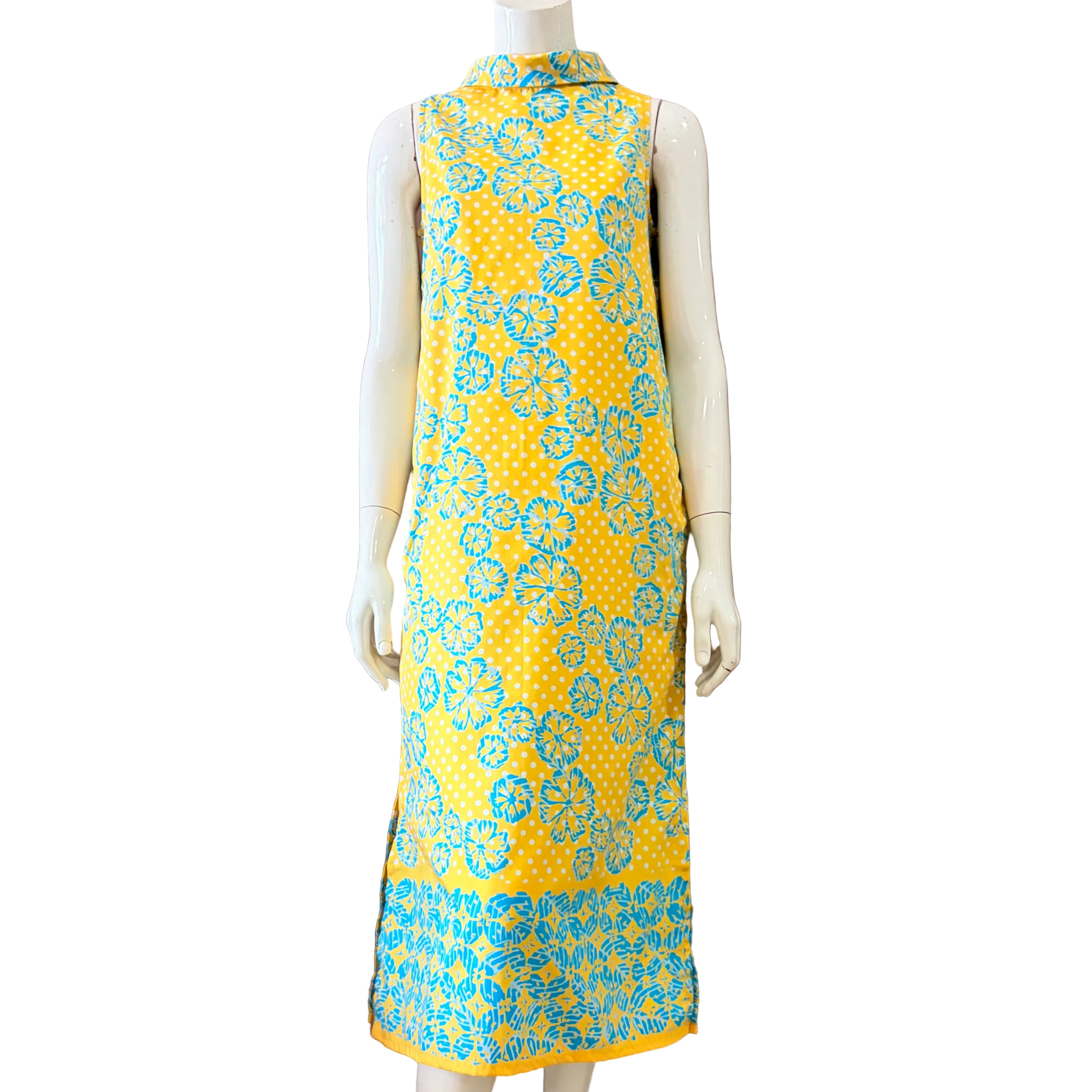 Mannequin wearing a yellow dress with blue floral pattern. 