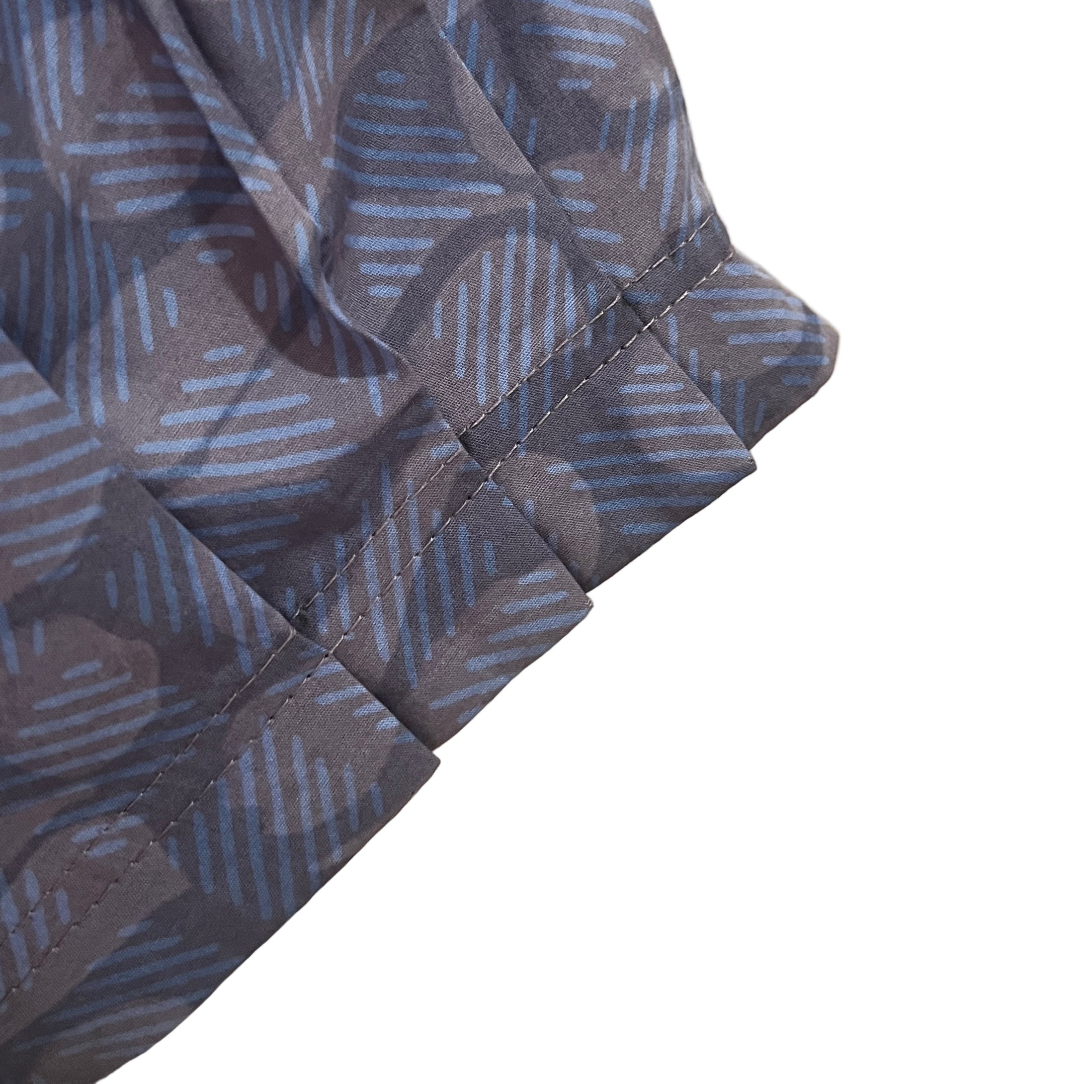 Close-up of a patterned fabric with a beige background