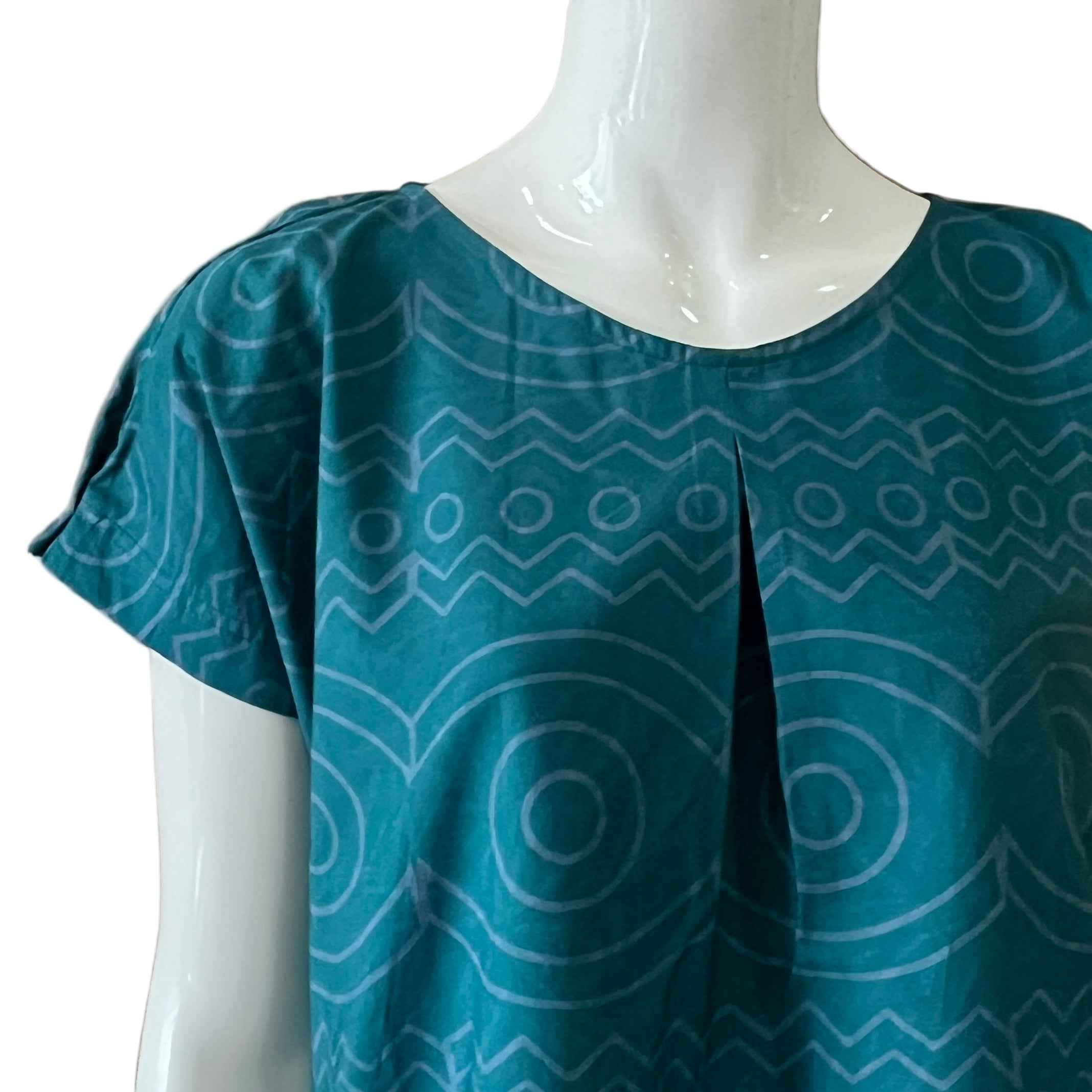 Teal handcrafted batik dress with geometric pattern. 