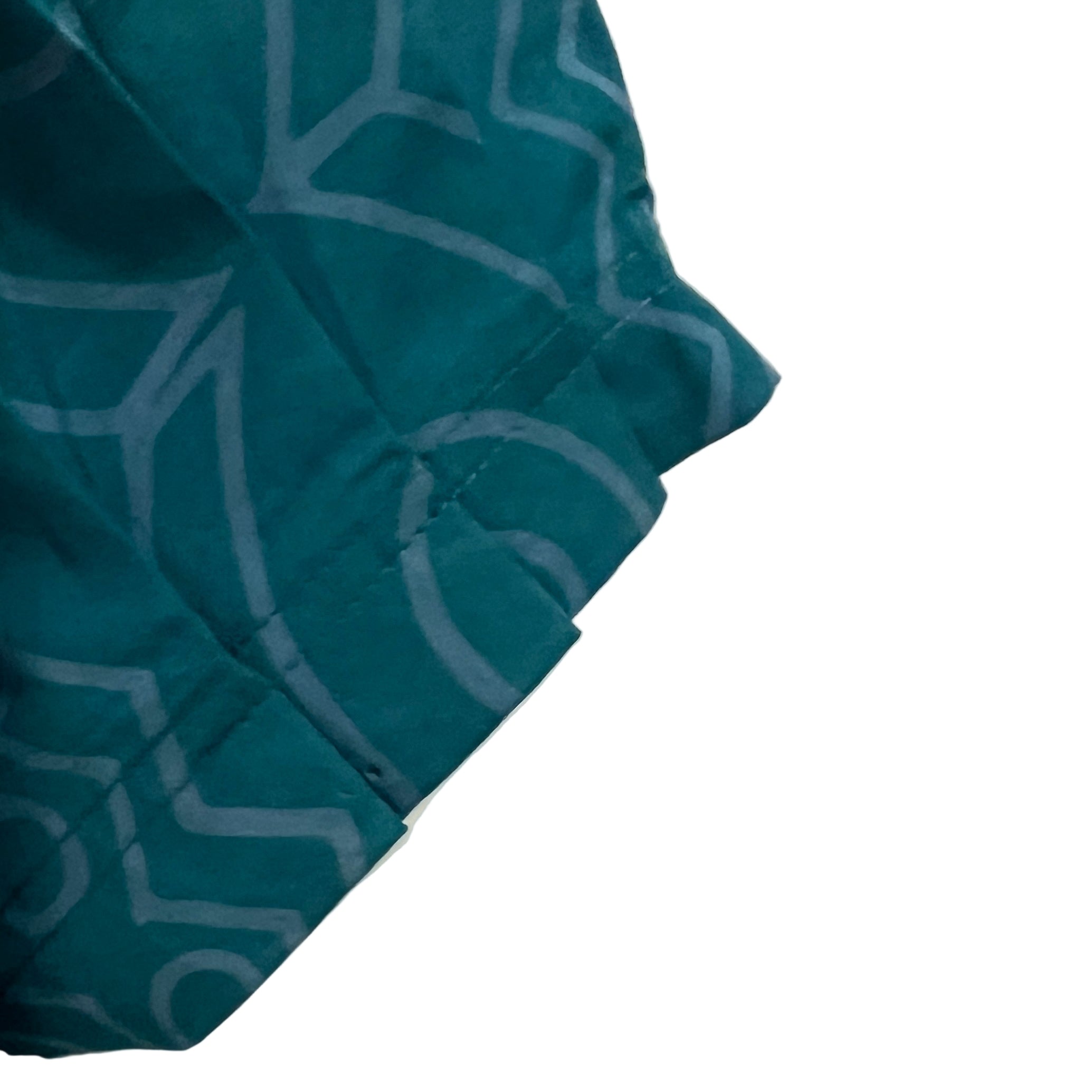 Teal fabric with a pattern on a beige background